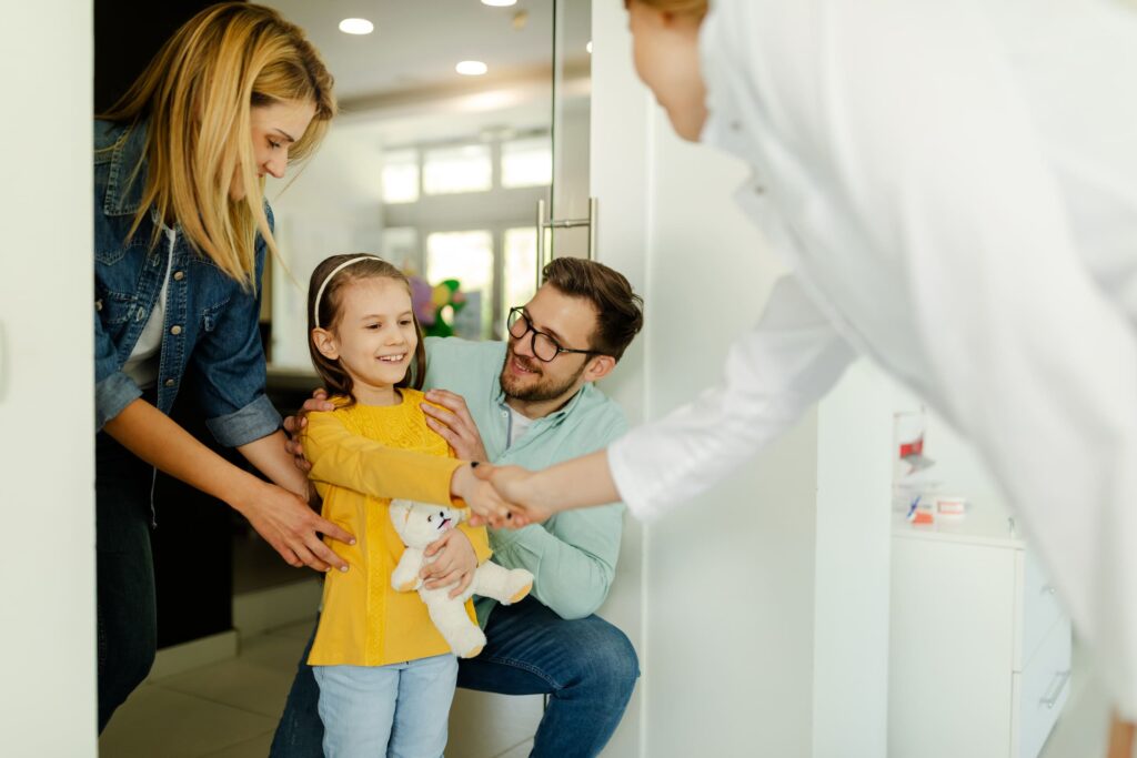 Happy family meeting a dentist for the first time, emphasizing the importance of choosing the right family dentist for personalized care.