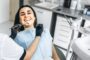 Happy patient during holistic dental exam with dentist